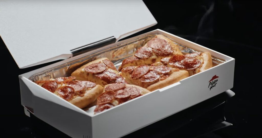 GenjiTalkGames - Pizza Hut Canada's Pizzawrmr is a 3D-printable pizza warmer that attaches to your PS5, using the console's heat to keep your slices piping hot. Download the STL files and build your own! #PizzaHut #PS5 #Gaming